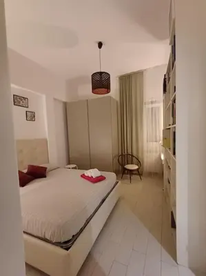 a bedroom with a bed and a chair in it at Nido rinnovato in Rome