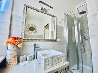 a bathroom with a sink and a mirror at Vatican City Historic Center -Luxury Flat with Garden and Private Parking in Rome