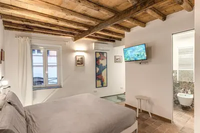 a bedroom with a bed and a bathroom at La Casa Dei Sogni in Rome