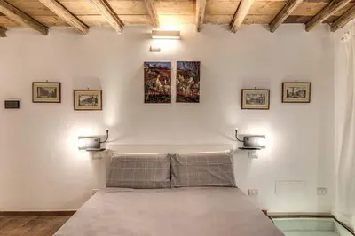 a bedroom with a bed with three pictures on the wall at La Casa Dei Sogni in Rome