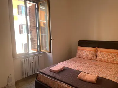a bedroom with a bed with two towels on it at Rosa di San Giovanni in Rome