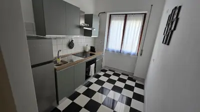 a kitchen with a black and white checkered floor at Ferrari House in Rome