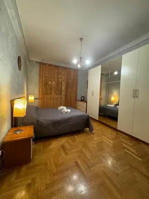 a bedroom with a bed and a wooden floor at Tatyana appartament in Rome