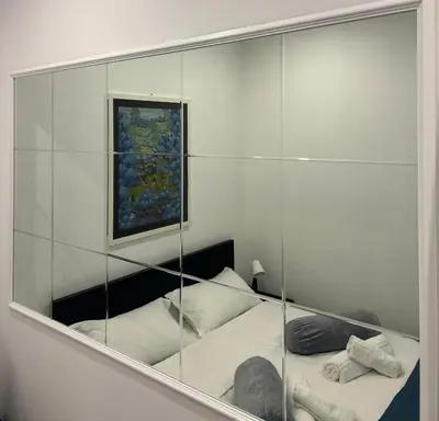 a reflection of a bedroom with a bed in a mirror at Love Roma Termini Apartment with Terrace in Rome