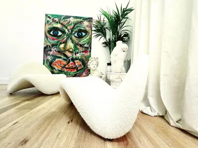 a room with a chair and a picture of a mask at B89 Luxury Gallery House Piazza Di Spagna in Rome