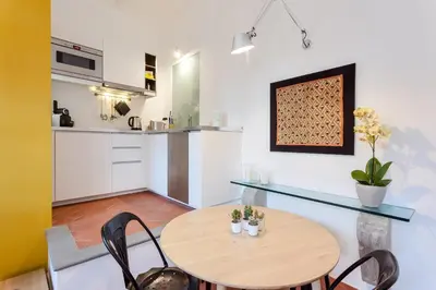 a kitchen and dining room with a table and chairs at Rome as you feel - Baullari with terrace in Rome