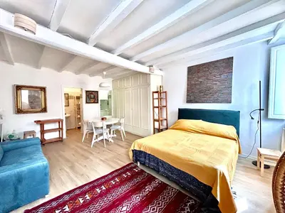 a bedroom with a bed and a table and chairs at Colosseo Lovely studio apartment in Rome