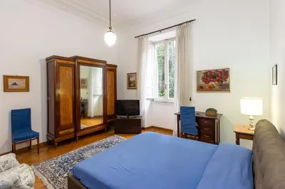 a bedroom with a bed and a couch and a window at Amazing San Giovanni in Laterano in Rome