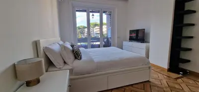 a white bedroom with a bed and a window at Nox Romana Apartments - Saint Peter - Large Flat with Terrace in Rome