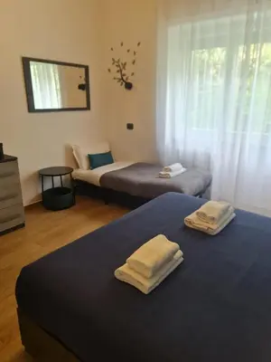 a bedroom with two beds with towels on them at La casa di Ricky in Rome