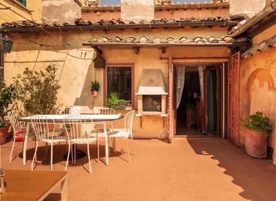 a patio with a table and chairs on a patio at Principessa Trevi in Rome