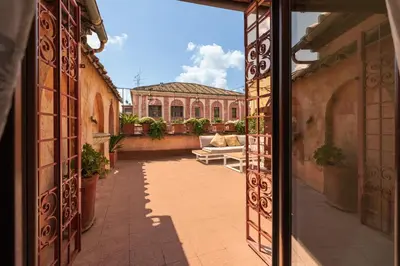 an open door to a courtyard with a couch in a building at Principessa Trevi in Rome