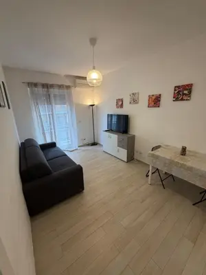a living room with a black couch and a table at Casa Caffarella in Rome