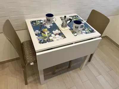 a white table with two chairs and two mugs on it at Casa Caffarella in Rome