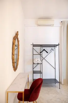 a room with a table and a mirror and a chair at Vita Nova House 3 camere 3 bagni perfetta per famiglie e gruppi a due passi da Termini in Rome