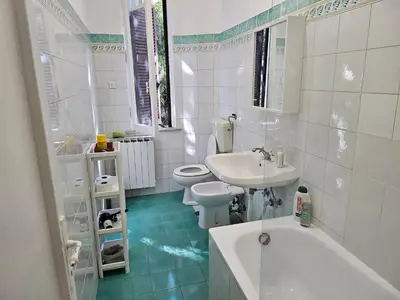 a bathroom with a sink and a toilet and a tub at Saint Peters Place 2BR near Vatican in Rome