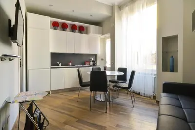 a kitchen with a table and chairs in a room at Lata Luxury Apartment in Rome