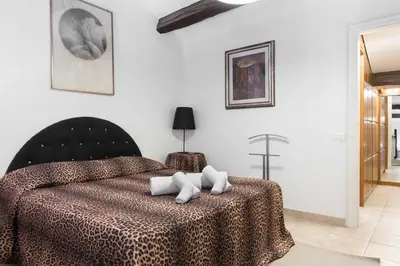 a bedroom with a bed with a cheetah printspread at Casa Enriqueta in Rome