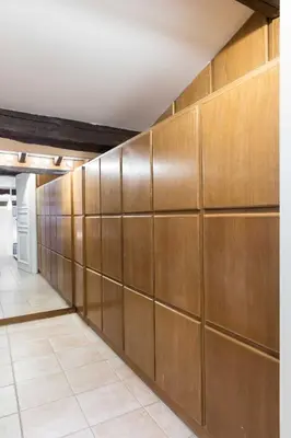 a wall of wood panels in a hallway at Casa Enriqueta in Rome
