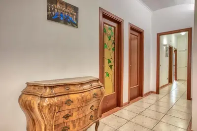 a room with a wooden cabinet and a hallway at Dimora Savorelli, ampio appartamento zona Vaticano in Rome