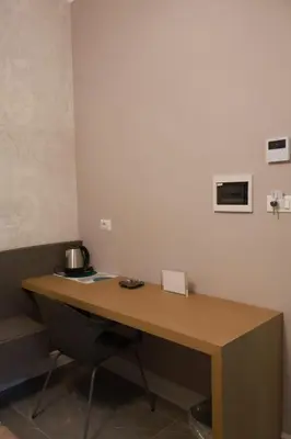 a wooden desk in a room with a table at COLOSS IMPERIAL SUITE Guest House in Rome