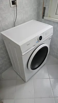 a white washing machine sitting on top of a counter at Domus Imperiali in Rome