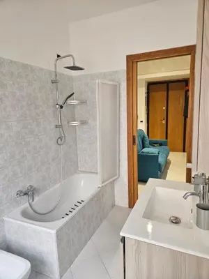 a bathroom with a shower and a tub and a sink at Domus Imperiali in Rome