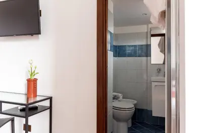 a bathroom with a toilet and a sink at Torripa Group - Prati in Rome