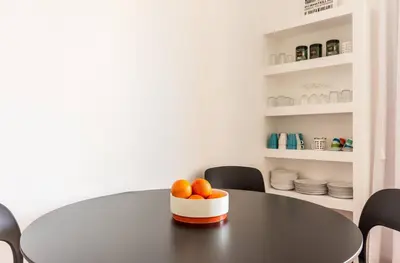 a black table with a bowl of oranges on it at Torripa Group - Prati in Rome