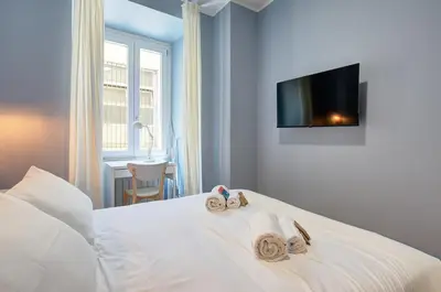 a bedroom with a white bed with towels on it at Vatican Lante Apartment in Rome