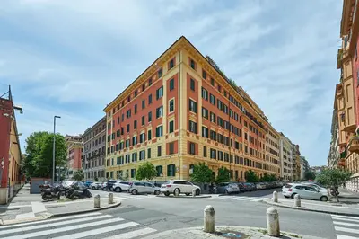 a large orange building with cars parked in front of it at Vatican Lante Apartment in Rome