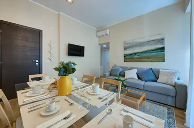 a living room with a table and a couch at Vatican Lante Apartment in Rome