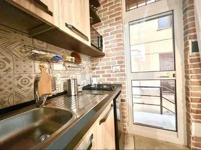 a kitchen with a sink and a brick wall at Suite Old Testaccio 2 in Rome