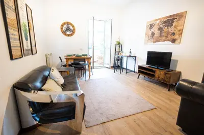 a living room with a leather couch and a television at Urban Trastevere Rome apartment Ripa 11 in Rome