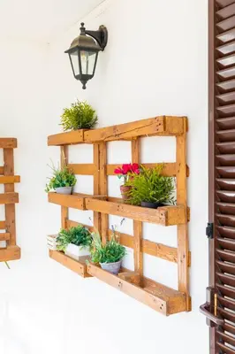 a wooden shelf with potted plants on a wall at Boutique Trastevere Rome apartment Ripa 12 in Rome