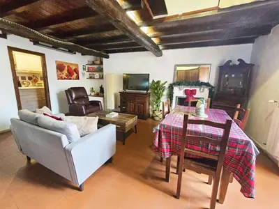 a living room with a table and a couch at Pantheon Penthouse in Rome