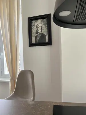 a picture of a woman on a wall with a chair at Saint Paul Gateway in Rome