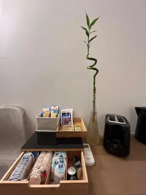 a coffee table with a box of drinks and a vase at Saint Paul Gateway in Rome