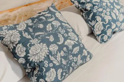 a blue and white pillow sitting on top of a bed at Monti Urban Loft by Valentina's Dream in Rome