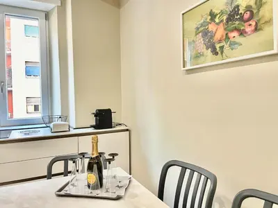 a dining room with a table with two chairs and a window at SAINT PETER home and holiday apartment in Rome