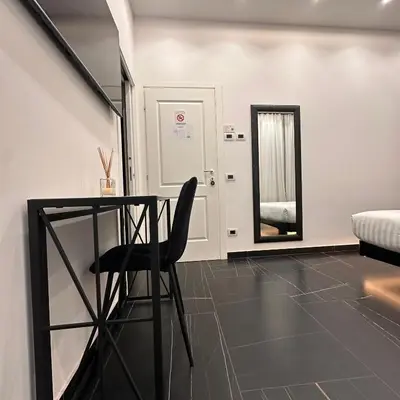 a bedroom with a bed and a sink and a mirror at Medaglie d'Oro Vaticano in Rome