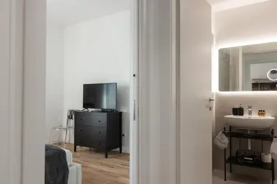 a small bathroom with a sink and a mirror at Rienzo Apartment near Vatican in Rome