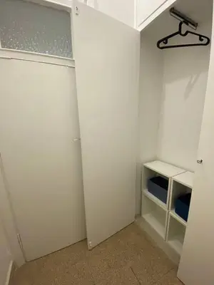 a walk in closet with white walls and a shelf at Armandino's sweet home Roma in Rome