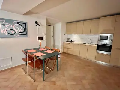 a kitchen with a table and chairs in a room at Peaceful hidden gem near Metro A and Colosseum in Rome
