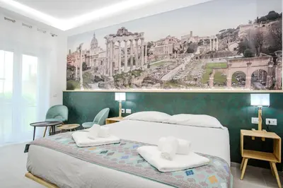 a bedroom with a large bed with two white towels at Domus suites in Rome