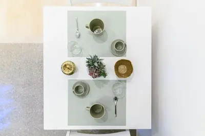 a white cabinet with cups and dishes on it at Giardinetto 14 in Rome