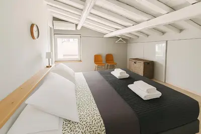a bedroom with a large bed with two white towels at The Artist's nest - Trastevere- Rome in Rome