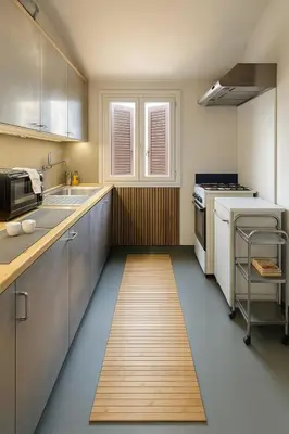 a kitchen with white cabinets and a wooden floor at The Artist's nest - Trastevere- Rome in Rome