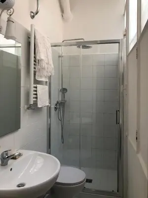 a bathroom with a shower and a toilet and a sink at Boschetto Apartment in Rome