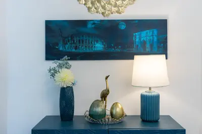 a table with two vases and a lamp on it at Carpe Diem by Rental in Rome in Rome